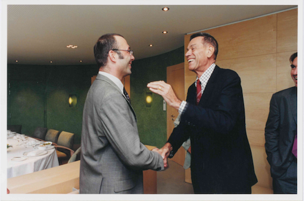 Two men in suits shaking hands