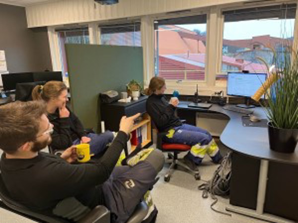 Photo of three workers in an office at the plant.